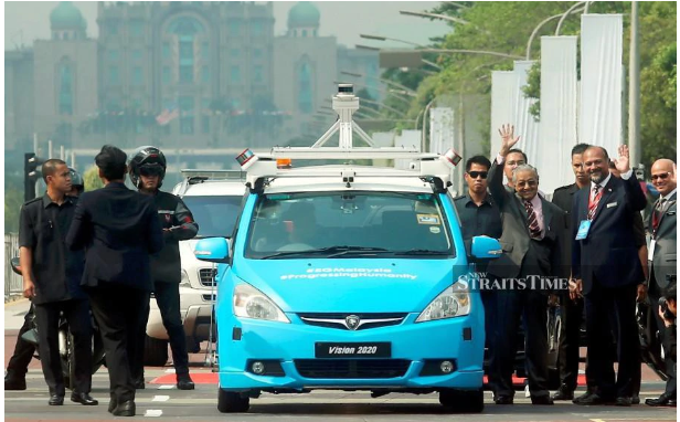 Prime Minister Tun Dr Mahathir Mohamad with Communications and Multimedia Minister Gobind Singh Deo wave before taking a ride in the autonomous car during the launch of 5G Malaysia: Progressing Humanity Programme in Putrajaya. - NSTP/MOHD FADLI HAMZAH