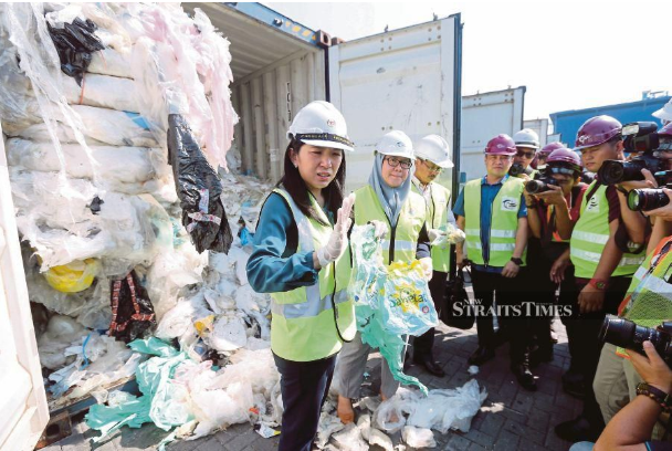 Energy, Science, Technology, Environment and Climate Change Minister Yeo Bee Yin (left) inspecting the containers filled with foreign waste in Port Klang yesterday. -NSTP/ SADDAM YUSOFF